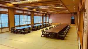 a conference room with tables and chairs and windows at 洗心和方 Senshin Waho in Awaji +62 photos