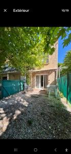a house with a bench in front of it at Le Pin Penché in Monteux