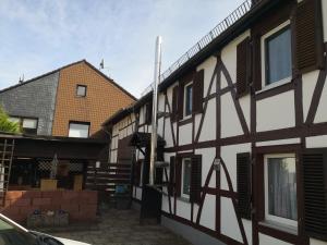 a building with black and white paint on it at Haus am Fluss in Urft