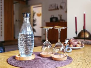 two bottles and two glasses on a table at Ferienwohnung Stork in Möhnesee