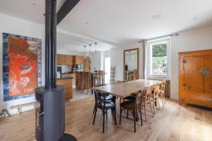 a kitchen and dining room with a wood stove at Chalet La Llyre Vallorcine in Vallorcine