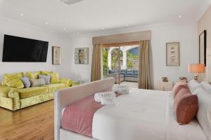 a bedroom with a large white bed and a couch at Karat Villa Lusso in Adeje