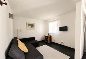 a living room with a couch and a tv at A Cerca - F in Lagos