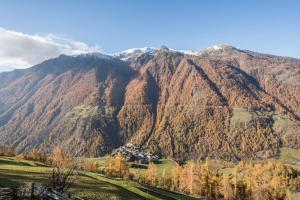 a mountain range with a house in front of it at Untervernatsch Fewo Enzian in Senales +12 photos