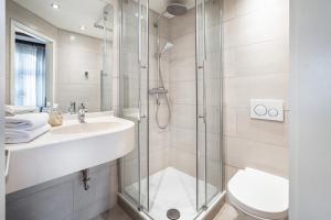 a bathroom with a shower and a sink and a toilet at Ferienwohnungen Fehlingstr 28 in Travemünde +27 photos