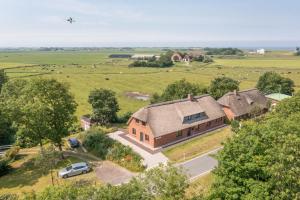 an aerial view of a home with a plane flying over it at Nordergaard Hus in Pellworm