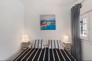 a bedroom with a large bed with two night stands at Casa Paula - 21 in Arinaga +20 photos