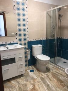 a bathroom with a toilet and a sink and a shower at Luján 2 B entre campo y ciudad in Puntallana