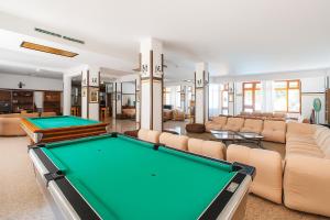 a pool table in a living room with couches at Hotiday Vieste Centro in Vieste