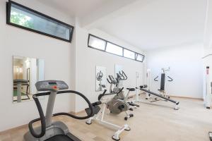 a gym with treadmills and exercise bikes in a room at Hotiday Vieste Centro in Vieste