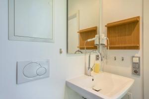 a bathroom with a sink and a mirror at Ferienhaus Am Heidenbach in Deggenhausertal +22 photos