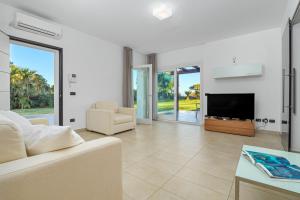 a living room with a couch and a tv at Villa Marconi Apartment 6 in Golfo Aranci