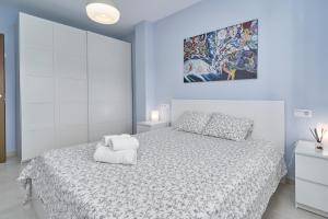 ein Schlafzimmer mit einem Bett und einem Gemälde an der Wand in der Unterkunft Recreo 10 in Torrox