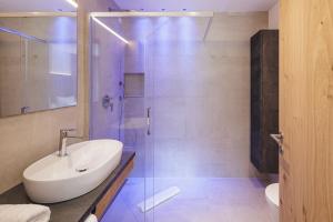 a bathroom with a sink and a glass shower at Apartments Silva Mountain in San Giovanni in Val Aurina +11 photos
