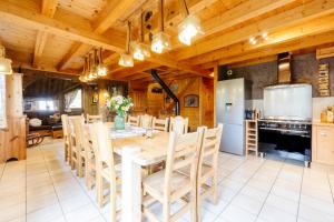 a kitchen and dining room with a table and chairs at Chalet le jardin d'hiver in La Toussuire