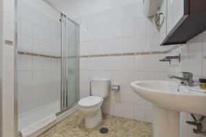 a bathroom with a toilet and a sink at Apartamento Bregador in Playa de San Juan +12 photos