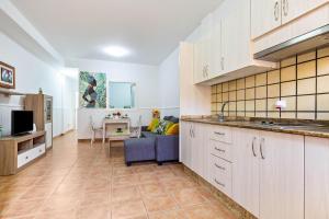 a kitchen with a sink and a couch in a room at Savoa Sea 365 in Tarajalejo +13 photos