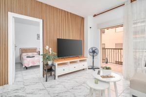 a living room with a flat screen tv on a wall at Aurora Mar Del Sol in Almuñécar