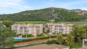 an apartment complex with a mountain in the background at Olot Llenaire in Port de Pollensa