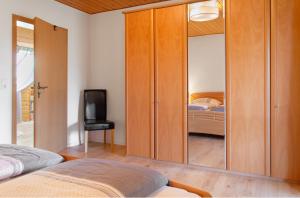 a bedroom with a sliding glass door with a television at Ferienwohnung Apfelblüte in Burgbernheim