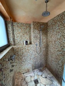 a tiled bathroom with a shower with a shower at Separate Area mit Schlafzimmer und Badezimmer in Heroldsberg