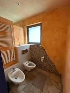 a bathroom with a toilet and a sink and a window at Separate Area mit Schlafzimmer und Badezimmer in Heroldsberg +2 photos