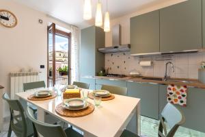 a kitchen with a table with plates and glasses on it at La Terrazza House in Lanciano
