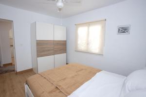 a white bedroom with a bed and a window at Garten und Pool in San Vicente del Raspeig +19 photos