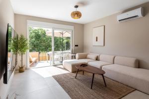 a living room with a couch and a table at Casa Eva in Estepona