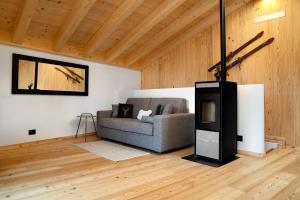 a living room with a couch and a fireplace at Bio Maso Nido Verde in Frassilongo