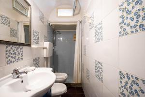 a bathroom with a sink and a toilet at Bilocale - Rosa seaview in villa in Santa Cesarea Terme +16 photos