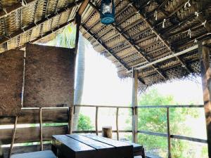 a room with a table and a straw roof at Diamond Mount Villa in Dambulla
