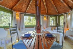 a dining room with a wooden table and chairs at Casa Penthouse in Porto Rotondo