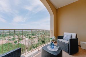 a balcony with two chairs and a table with a view at The Seaside Retreat in Pula