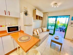 a kitchen and living room with a couch and a table at Paradise Dreams in Maspalomas +13 photos