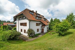a large white house on a green field at Sonnenterasse im Schwarzwald in Freudenstadt
