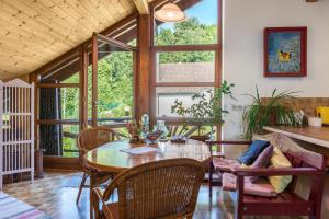 a dining room with a table and chairs at Rose Garden in Heiligenberg