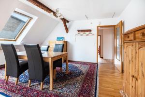 a dining room with a wooden table and black chairs at Monteurwohnung Schulze in Bad Bodenteich