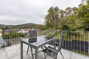 a table and a chair on a balcony at Ferienhaus Hegne in Allensbach