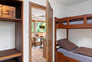 a bedroom with bunk beds and a dining room at Zugspitzstudio Apartment in Ehrwald