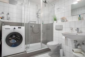 a bathroom with a shower toilet and a sink at Ferienwohnung Karma in Kressbronn am Bodensee +14 photos