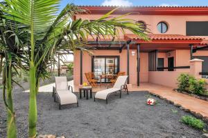 eine Terrasse mit Stühlen und einem Tisch in einem Haus in der Unterkunft Casa Bonita Lajares 2 in Lajares