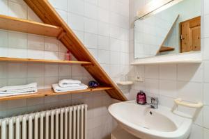 a bathroom with a sink and a mirror and a radiator at Landhaus Graf in Kniebis +23 photos