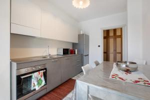 a kitchen with a table and a counter top at Casa Rosa Aosta in Aosta