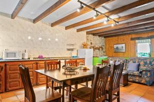 a kitchen and dining room with a table and chairs at Lorences B in Caunedo +17 photos