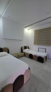 a room with two beds and a projection screen at dar saoussen in Triffa +33 photos