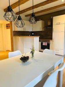 - une cuisine avec une table blanche et des chaises blanches dans l'établissement Ferienwohnung Bauernpfad, à Kressbronn am Bodensee