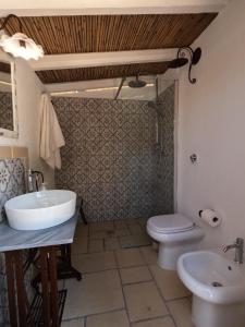 a bathroom with a sink and a toilet at Il Trullo - Tia Maria Country Inn in Racale