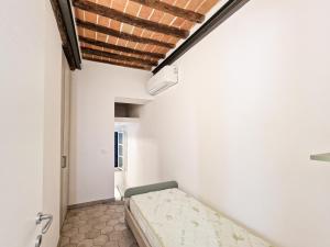 a bedroom with a bed in a room at Appartamento Campo City Center in Marina di Campo