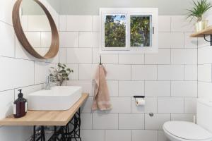 a white bathroom with a sink and a mirror at Casa Rural Siete Puertas in Tafira +22 photos